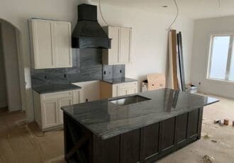 Kitchen remodel in progress with black quartzite countertops