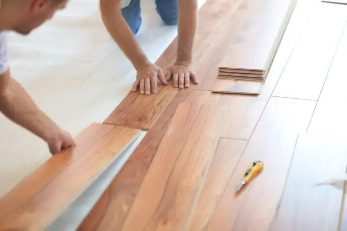 Contractor installing laminate flooring
