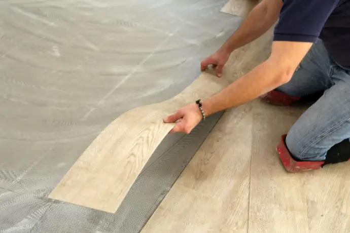 Contractor Installing Luxury Vinyl Flooring